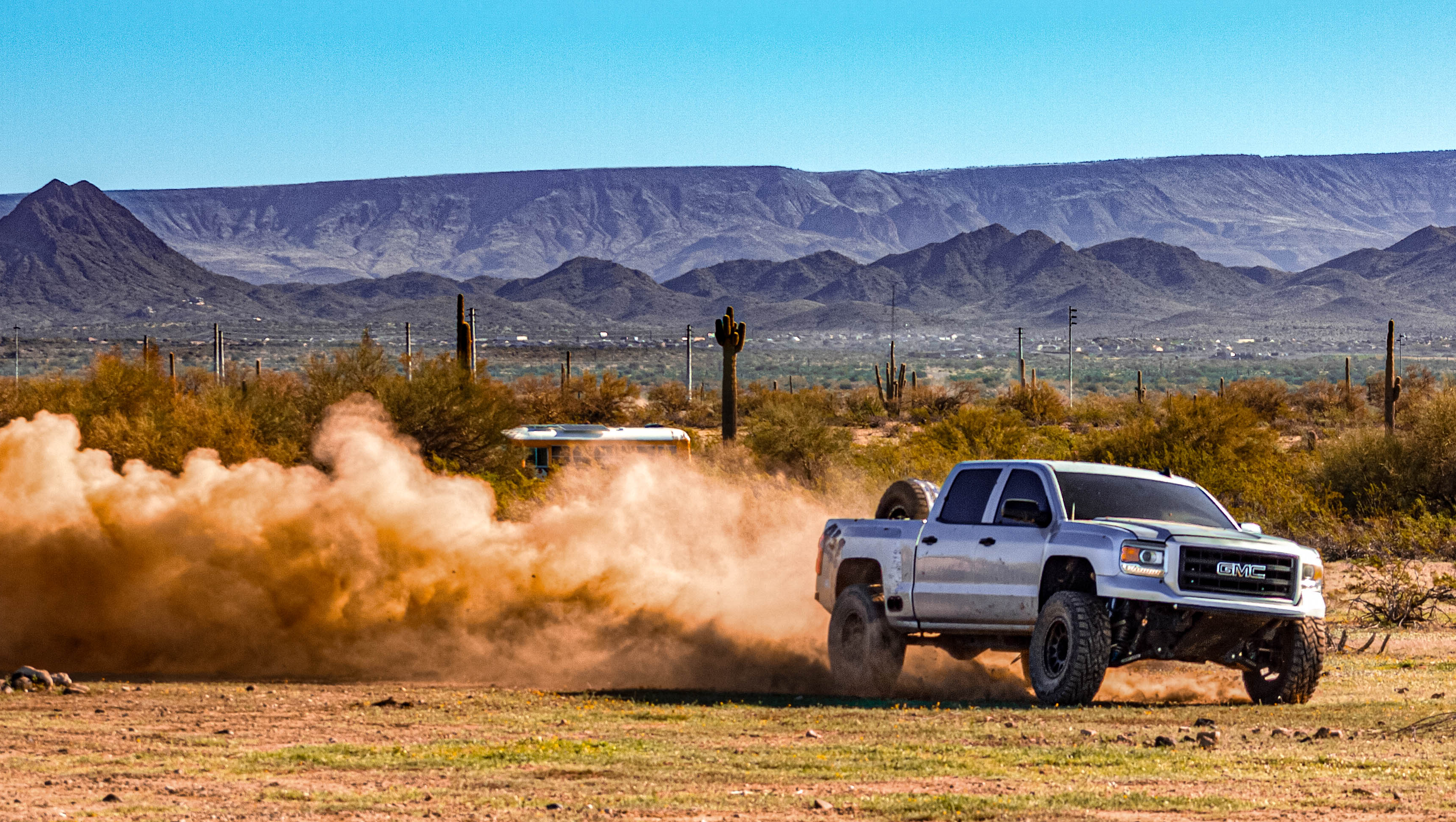 Off-road truck driving through desert terrain